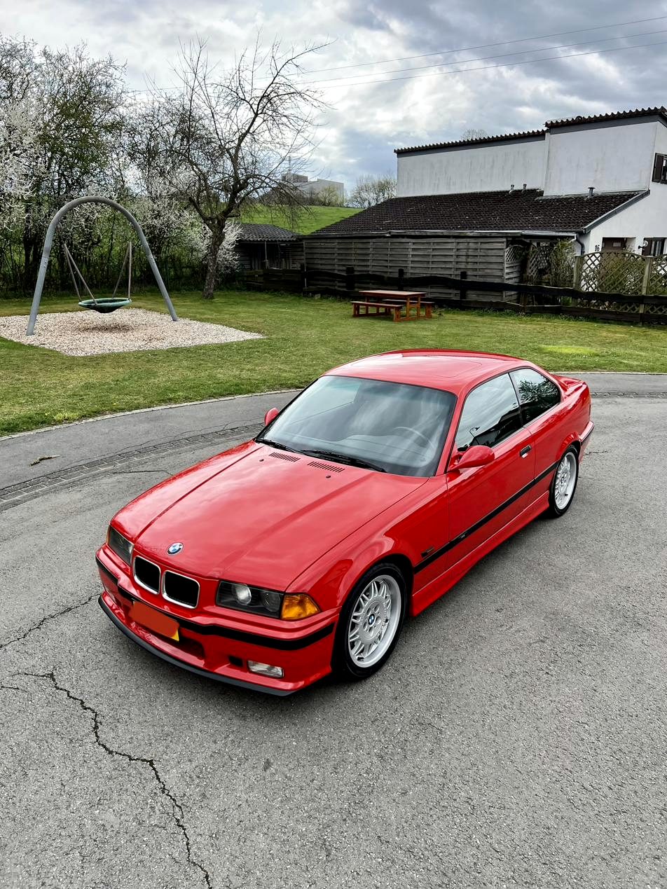 Red BMW E36 M3 in daylight after the full detail